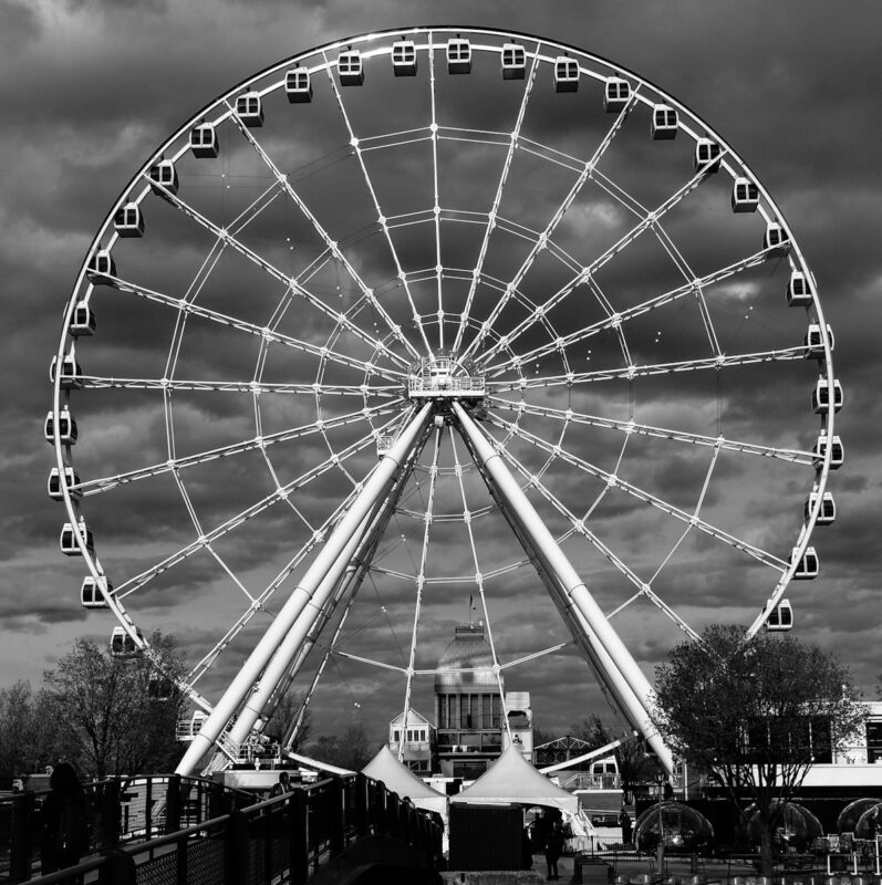Photo by philippe collard grayscale photography of ferris wheel near building