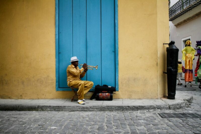 sitting man wearing yellow shirt during daytime