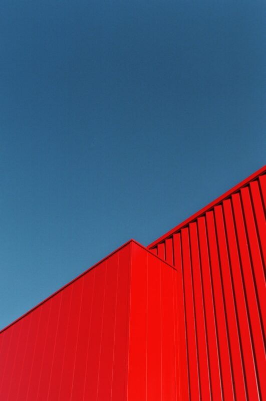 a red building with a blue sky in the background