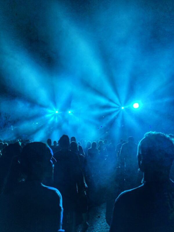 a group of people standing in front of a stage