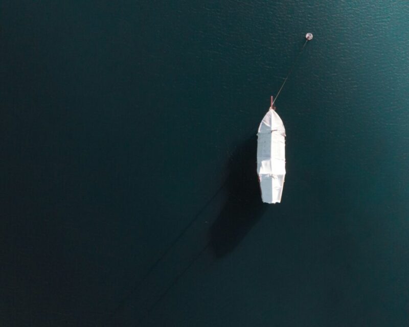 white boat on body of water during daytime