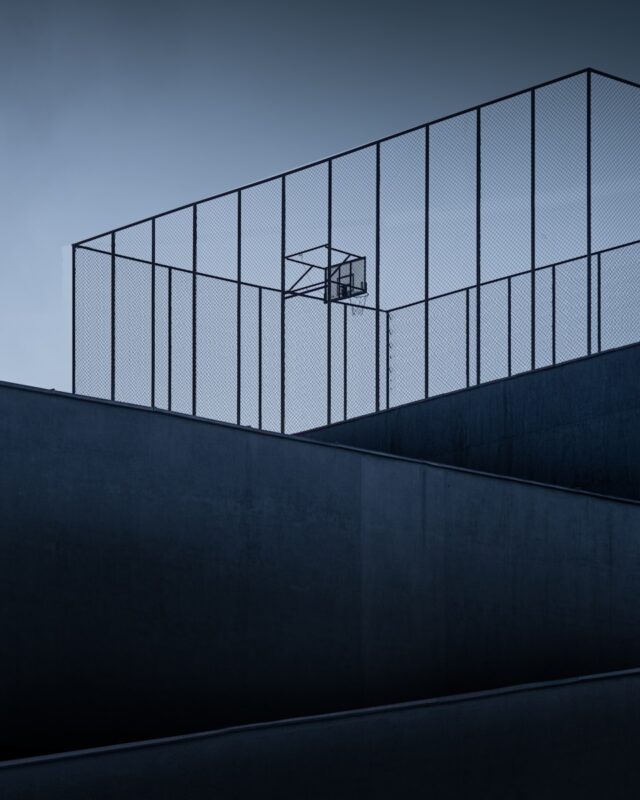 A man riding a skateboard down the side of a ramp